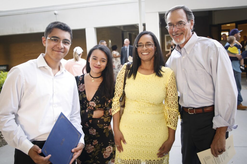 Student after 2019 Honors Convocation Award ceremony with family.