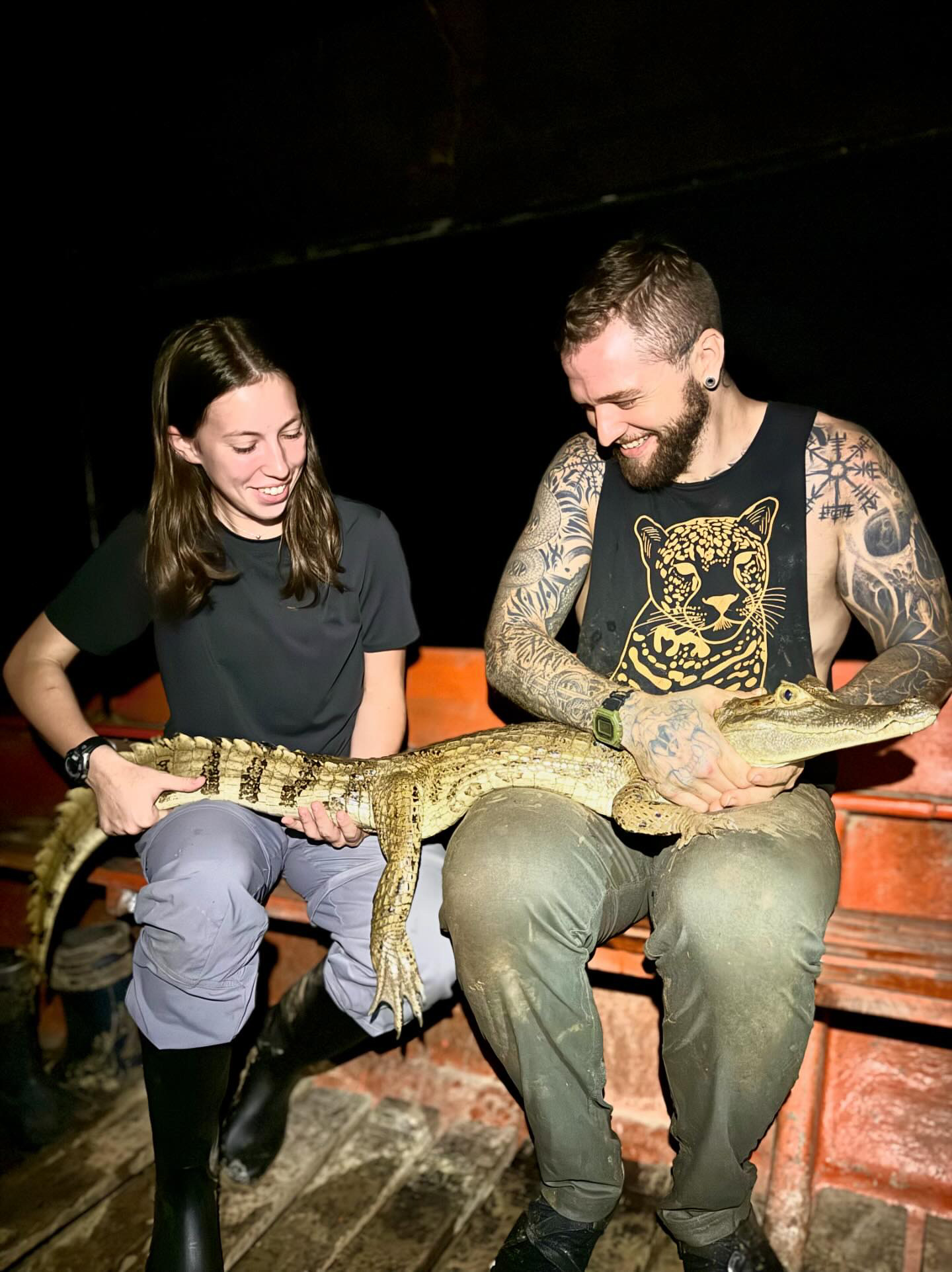 Maci Mize and biologist Dylan Singer pictured with caiman
