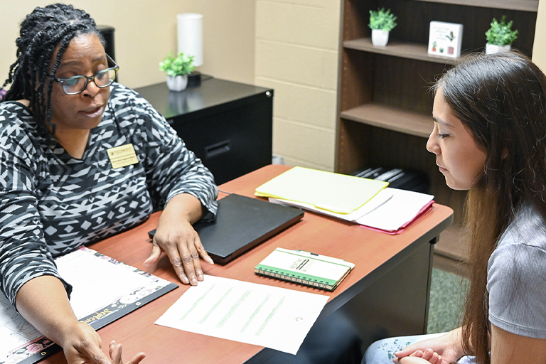 Advisor and student in a meeting.