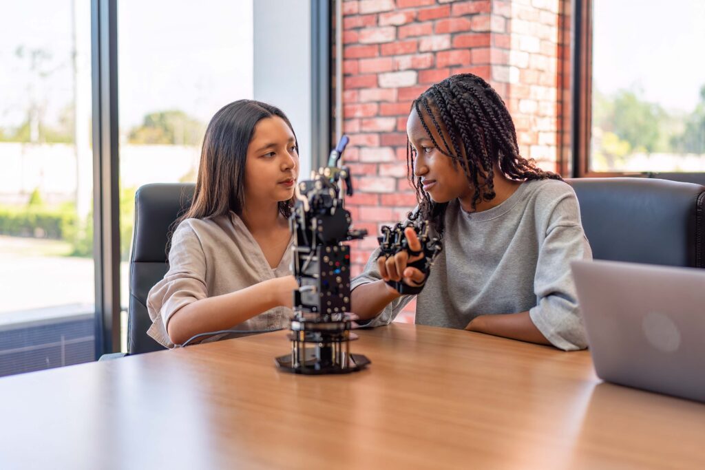 Teenager children learning with new innovation robotic hand interface hand control in classroom