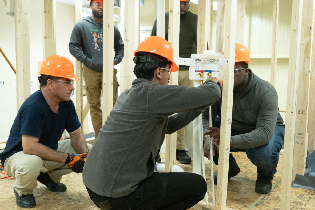Plumbing students working in class.
