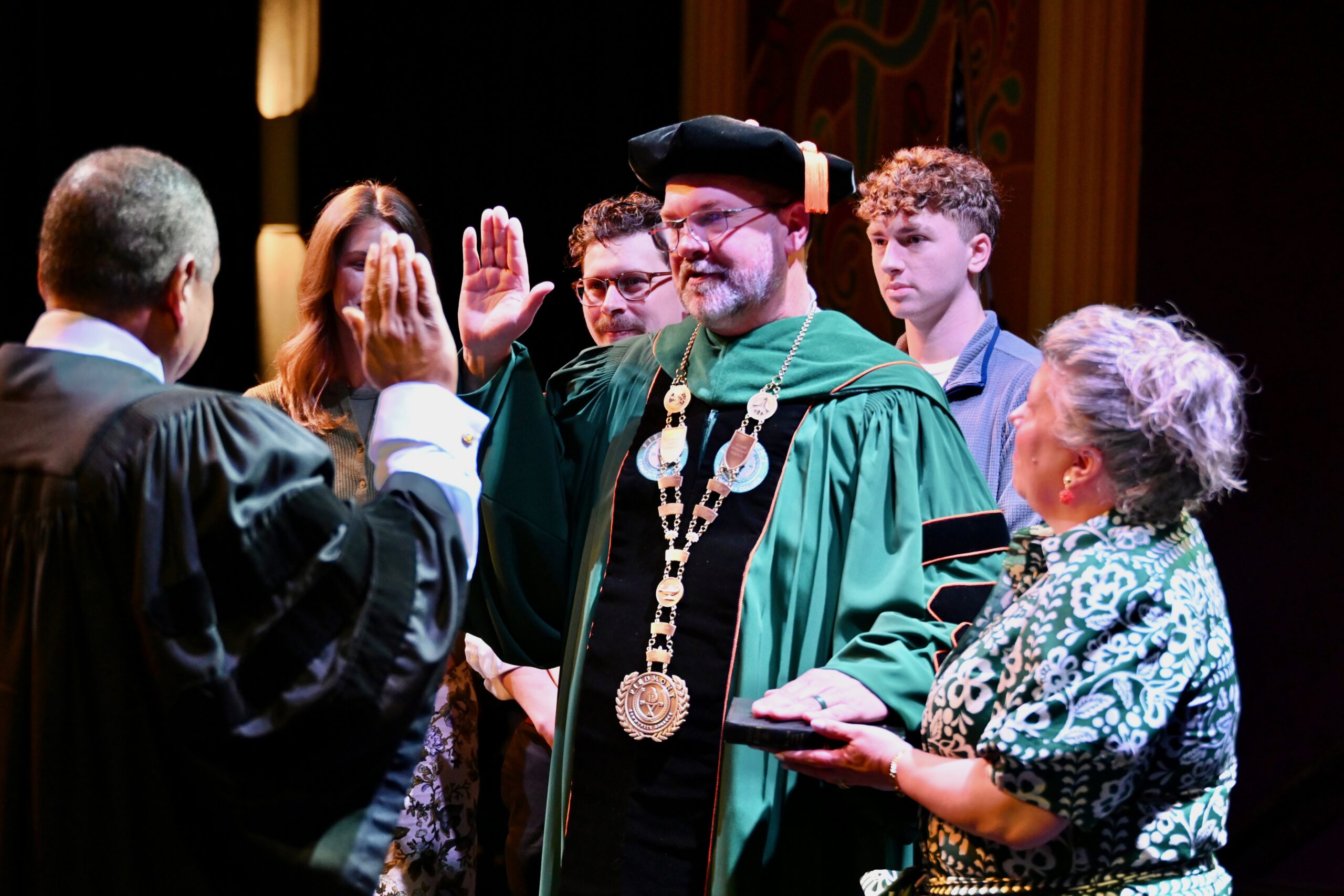 Dr. Lee being sworn in with family