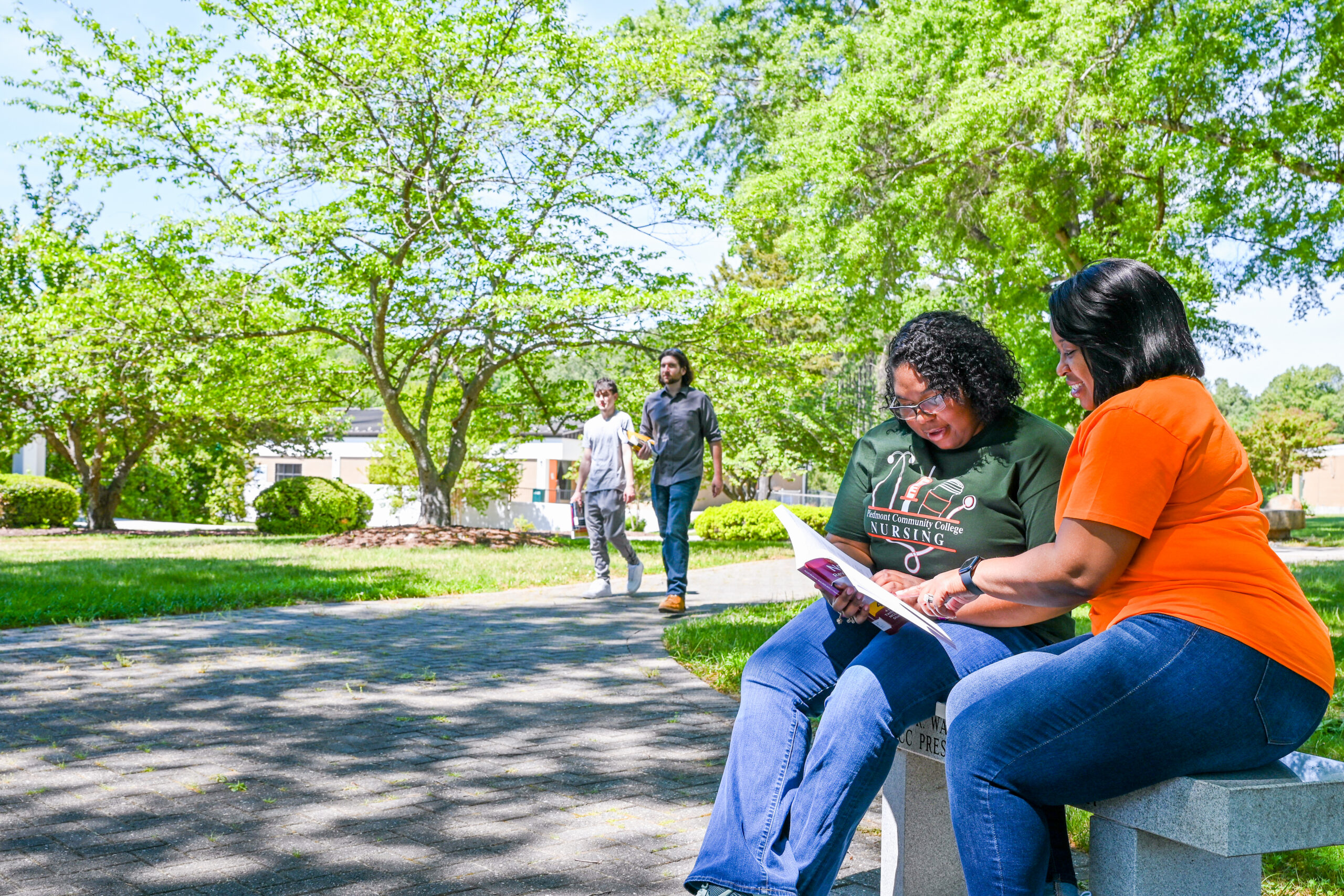 PCC students studying on campus bench.